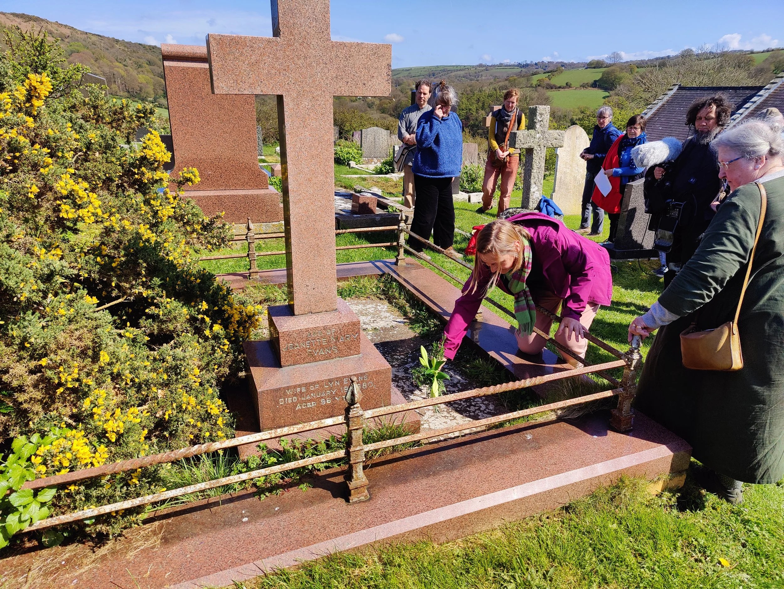 Laying flowers at the grave of Allen Raine
